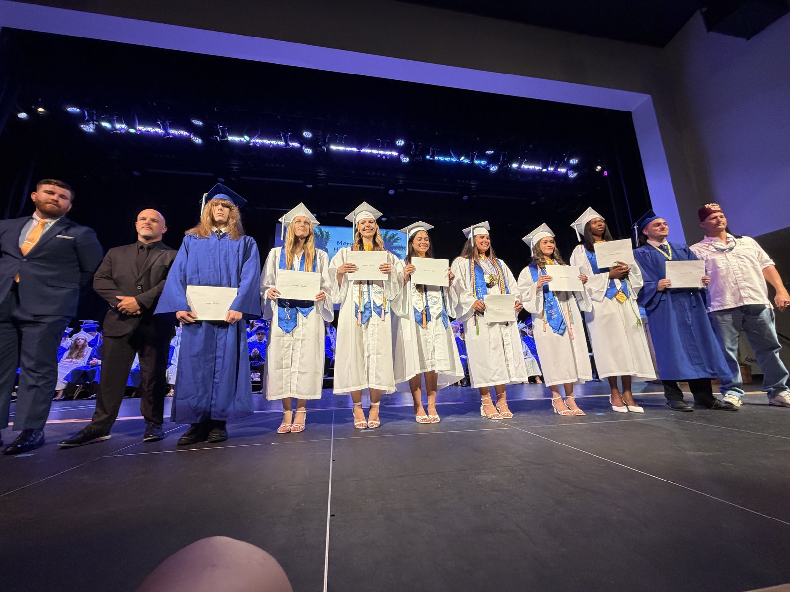 A second view of the Class of 2026 scholarship recipients receiving their awards on stage.